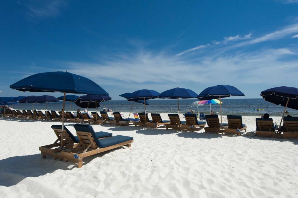 Beach chairs on the white sand near our Fort Walton Beach, FL, properties for sale