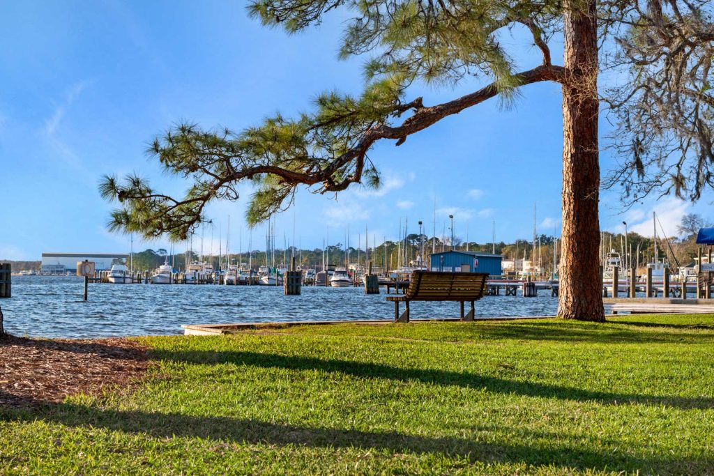 A bench next to the water near our Niceville, FL, real estate listings